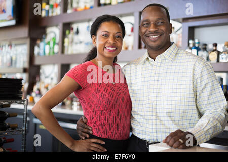 African American couple smiling in restaurant Stock Photo