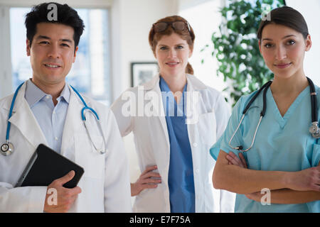 Doctors and nurse smiling in office Stock Photo