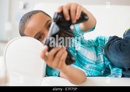 Mixed race boy playing video games Stock Photo