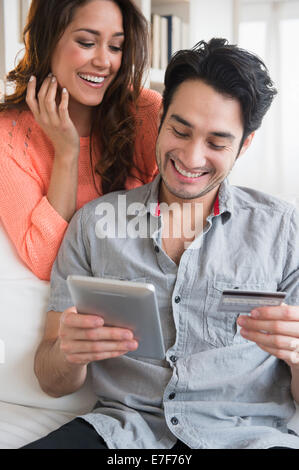 Couple shopping together on tablet computer Stock Photo