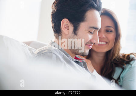 Couple smiling together on sofa