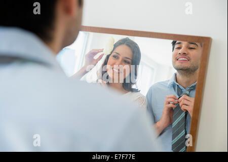 Couple dressing in front of mirror Stock Photo