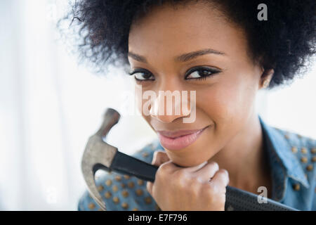 African American woman holding hammer Stock Photo