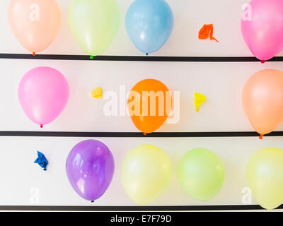 Popped balloons on wall Stock Photo