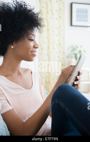 African American woman using tablet computer