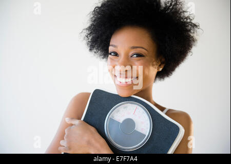 African American woman holding scale Stock Photo