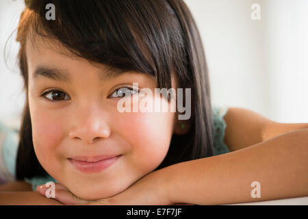 Filipino girl resting chin in hands Stock Photo