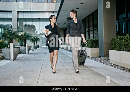 Businesswomen walking together outdoors Stock Photo