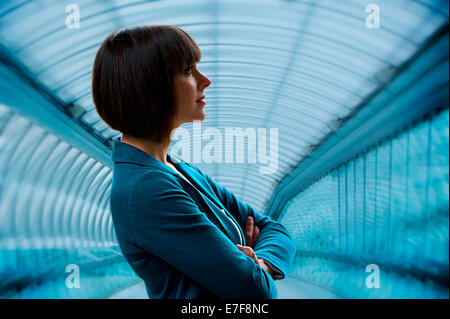 Caucasian businesswoman standing in tunnel Stock Photo
