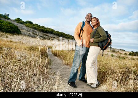 Black couple hugging on path in park Stock Photo - Alamy