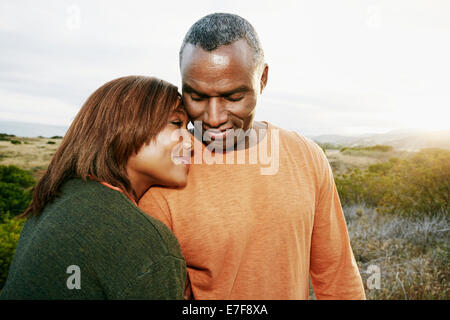 Black couple hugging on rural path Stock Photo - Alamy