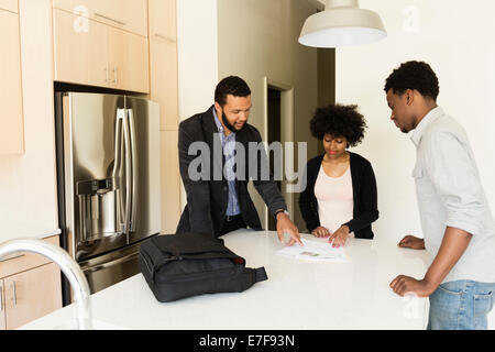 Couple talking to broker in new house