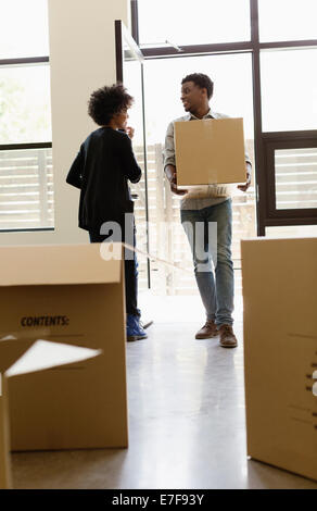 Couple hauling cardboard boxes to new house Stock Photo