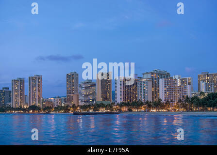 Illuminated city skyline on waterfront, Honolulu, Hawaii, United States Stock Photo