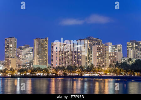 Illuminated city skyline on waterfront, Honolulu, Hawaii, United States Stock Photo