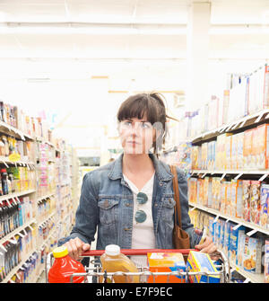 Caucasian woman shopping for groceries in store Stock Photo