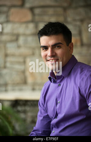 Hispanic businessman sitting indoors Stock Photo