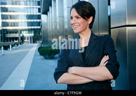 Caucasian businesswoman standing in city Stock Photo