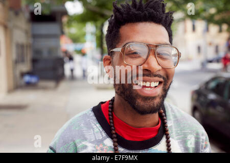 Black man smiling on city street