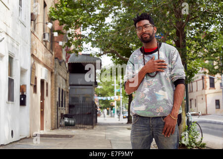 Black man standing on city street