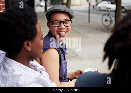 Women talking on city street Stock Photo