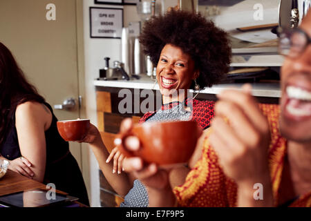 Woman laughing in cafe Stock Photo