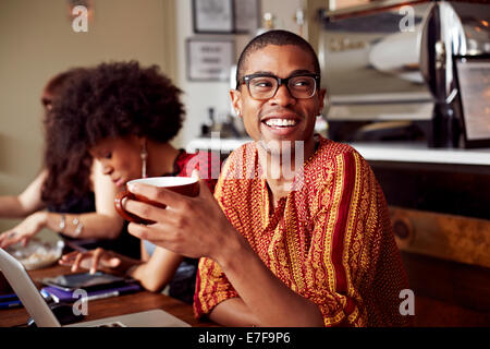 Man having cup of coffee in cafe Stock Photo