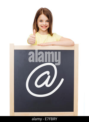smiling girl with blackboard showing thumbs up Stock Photo