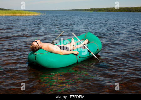 Man resting in a rubber boat Stock Photo