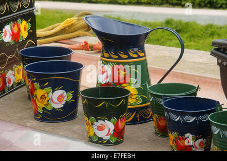 Brightly decorated hand painted canalware traditional water cans on a canal barge Stock Photo