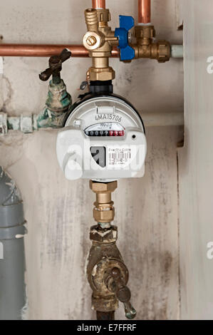 a water meter under a domestic sink with moldy walls the uk these meters have radio signals for collecting readings for Severn Stock Photo