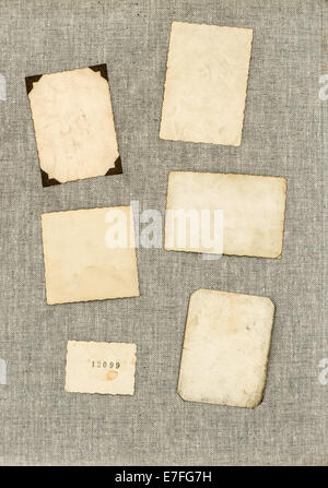 vintage photo frames on canvas textile background. aged paper sheets Stock Photo