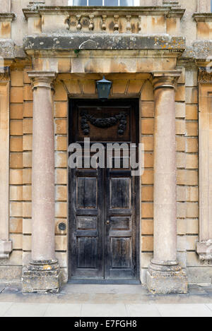 Large wooden entrance door with stone pillars Stock Photo