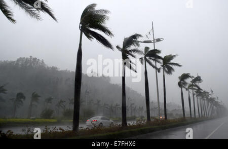 Fangchenggang, China's Guangxi Zhuang Autonomous Region. 16th Sep, 2014. Vehicles move against wind and rain in Fangchenggang City, south China's Guangxi Zhuang Autonomous Region, Sept. 16, 2014. The fifteenth Typhoon Kaimaegi hit Guangxi on Tuesday, affecting about 294,700 local residents and forcing the relocation of 25,800 people. Credit:  Lu Boan/Xinhua/Alamy Live News Stock Photo