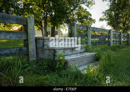 Wooden steps climbing through a solid fence at Appomattox National Park Stock Photo