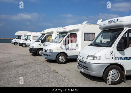 Row of motorhomes parked in car park for RVs / recreational vehicle along the coast with view over the sea Stock Photo