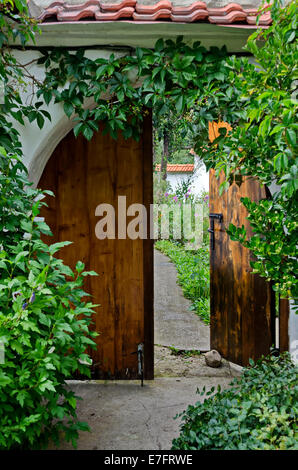 Door with flower for entrance in yard of monastery Stock Photo