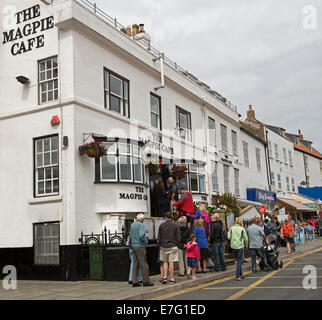 Long queue of people outside award Magpie Cafe to buy traditional meal of fish and chips at English coastal town of Whitby Stock Photo