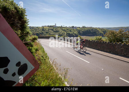 Pair of cyclists ride a path through the countryside on the Isle of Skye Stock Photo