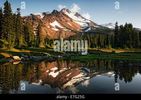 Central Oregon’s Mt Jefferson reflects into one of the many small tarns in the Jefferson Park Wilderness Area. Stock Photo