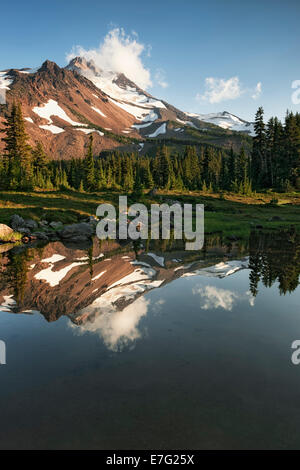 Central Oregon’s Mt Jefferson reflects into one of the many small tarns in the Jefferson Park Wilderness Area. Stock Photo