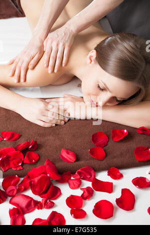 Masseur doing massage on woman body Stock Photo