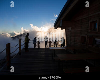 Climbers on the patio of Mantova Hut at sunset, Monte Rosa, Alps, Valle d'Aosta, Italy Stock Photo
