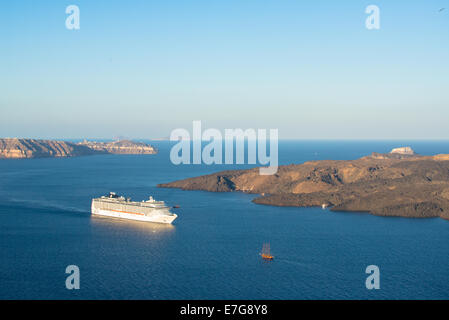 view at cruiseboat at Santorini island in Greece with the vulcanic new island Nea Kameni Stock Photo