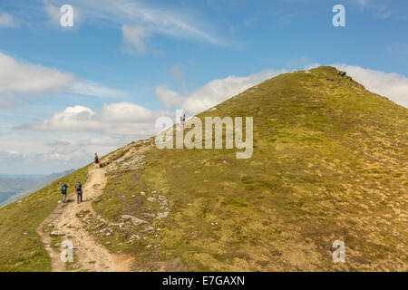 Hill walkers make their way to the summit of Ben Lomond on a clear sunny day Stock Photo