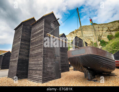 Tall thin traditional wooden fishing net huts on the harbour at the Stade in Hastings, East Sussex Stock Photo