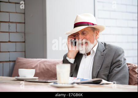 senior man smiling and talking on his cellphone Stock Photo