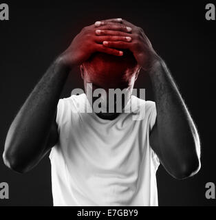 Pensive african man touching his head over black background Stock Photo