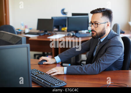 Asian businessman using computer in office Stock Photo