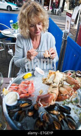 Woman eating a A plateau de fruits de mer  with fresh crab or fresh shellfish platter at Fishy Fishy restaurant Brighton UK